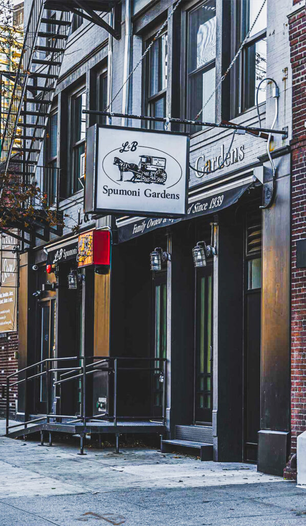 Exterior of LB Spumoni Gardens with signage displaying "Family Owned Since 1939"; red awning and brick facade visible.